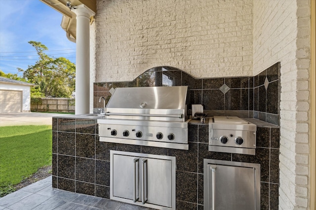 view of patio featuring grilling area, exterior kitchen, and sink