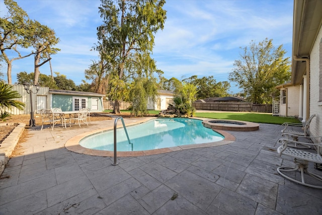 view of pool with an in ground hot tub and a patio