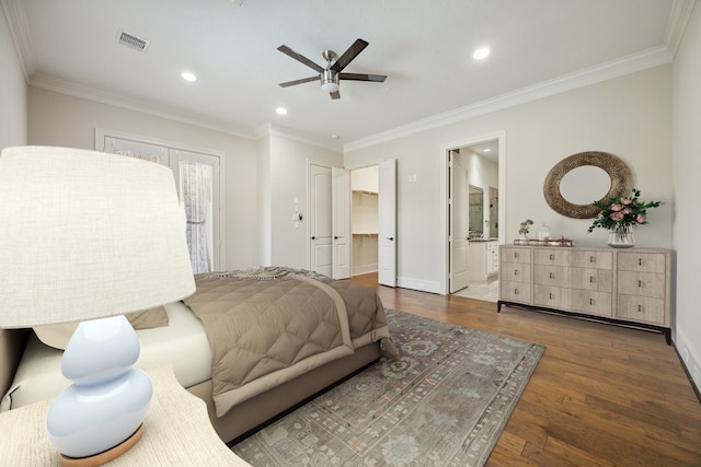 bedroom featuring ensuite bathroom, ceiling fan, dark wood-type flooring, and ornamental molding