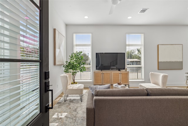 living room with ceiling fan, hardwood / wood-style floors, and a healthy amount of sunlight