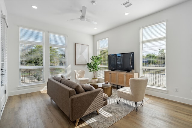 living room with hardwood / wood-style flooring and ceiling fan