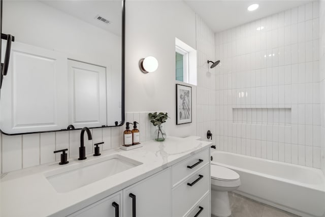 full bathroom featuring backsplash, vanity, tile patterned flooring, toilet, and tiled shower / bath