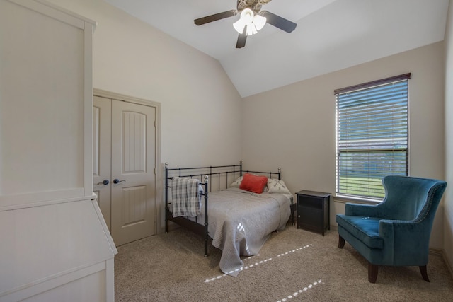 carpeted bedroom featuring vaulted ceiling, a closet, and ceiling fan