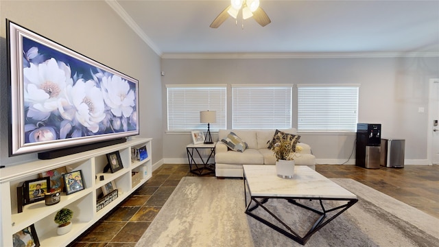 living area featuring baseboards, stone finish flooring, a ceiling fan, and crown molding