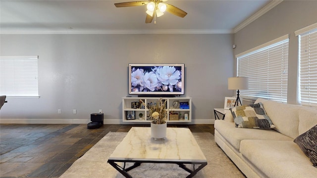 living room featuring ornamental molding, stone tile flooring, baseboards, and a ceiling fan