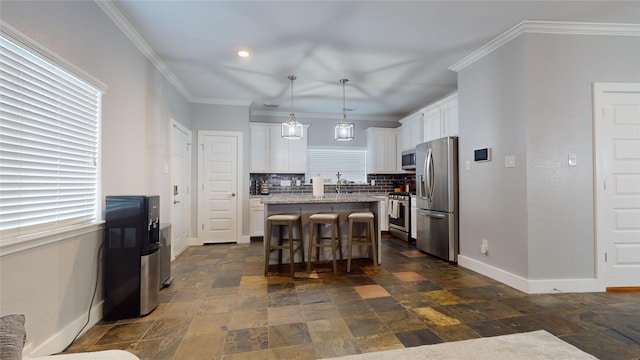 kitchen featuring a center island, stainless steel appliances, hanging light fixtures, white cabinets, and a kitchen breakfast bar