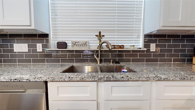 kitchen with a sink, white cabinets, and dishwasher