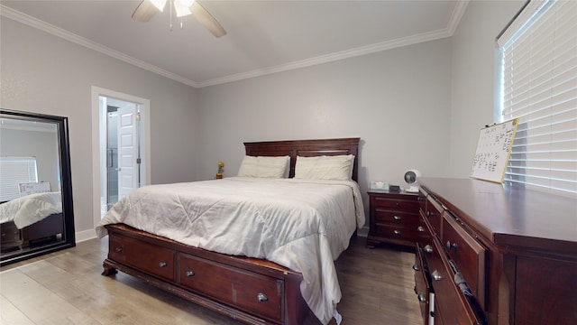 bedroom featuring crown molding, ceiling fan, ensuite bath, and light wood-style floors