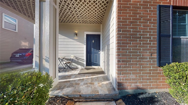 entrance to property featuring brick siding