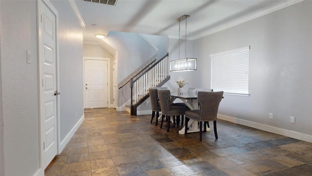 dining room with stairs, stone finish flooring, ornamental molding, and baseboards