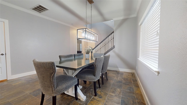 dining room featuring baseboards, visible vents, stairway, stone finish flooring, and crown molding