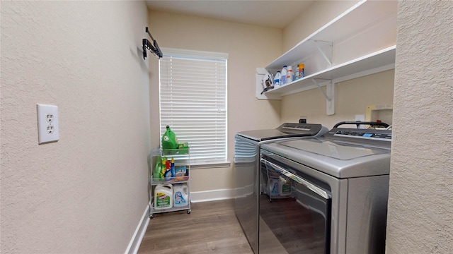 washroom with washer and clothes dryer, a textured wall, light wood-type flooring, laundry area, and baseboards