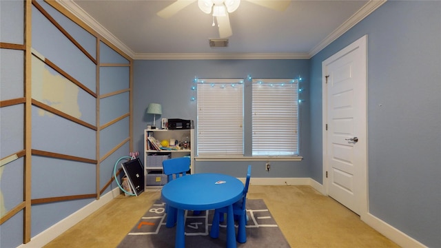 recreation room with ceiling fan, light carpet, visible vents, baseboards, and ornamental molding