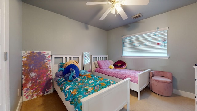 bedroom featuring baseboards, carpet, visible vents, and a ceiling fan