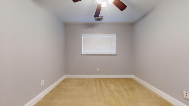 unfurnished room featuring baseboards, ceiling fan, visible vents, and light colored carpet