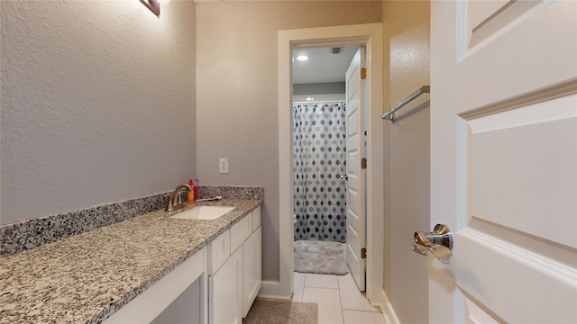 full bath featuring tile patterned flooring, baseboards, vanity, and a shower with curtain