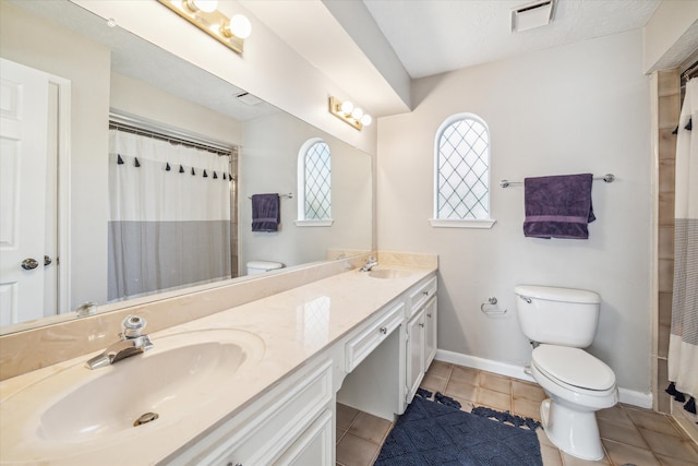 bathroom featuring tile patterned flooring, vanity, a shower with shower curtain, and toilet