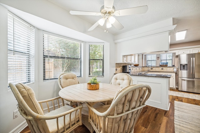 dining room with ceiling fan and dark hardwood / wood-style flooring