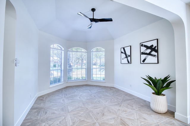 empty room with ceiling fan and light parquet flooring