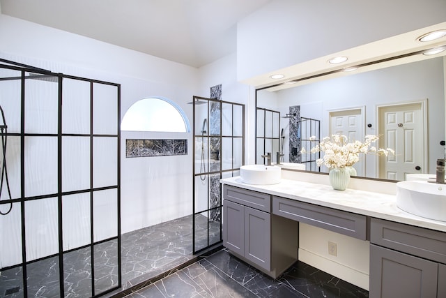 bathroom featuring a shower and vanity