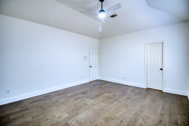 spare room featuring wood-type flooring, vaulted ceiling, and ceiling fan