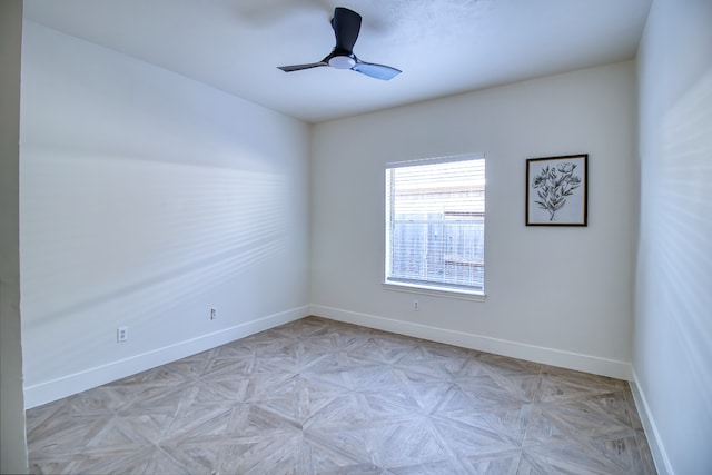 empty room featuring light parquet floors and ceiling fan