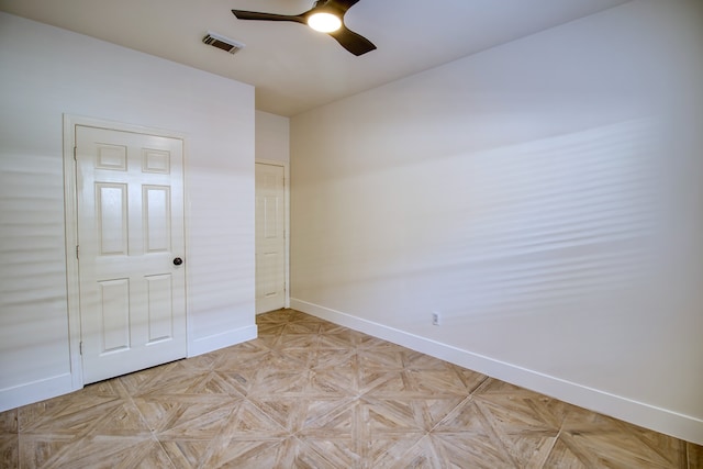 unfurnished bedroom with ceiling fan, a closet, and light parquet floors