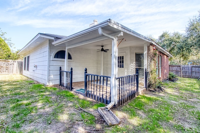 view of property exterior featuring a lawn and ceiling fan