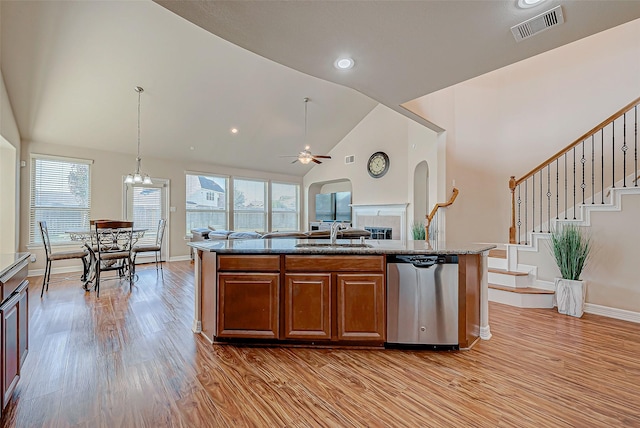 kitchen with a center island with sink, ceiling fan with notable chandelier, sink, hanging light fixtures, and stainless steel dishwasher