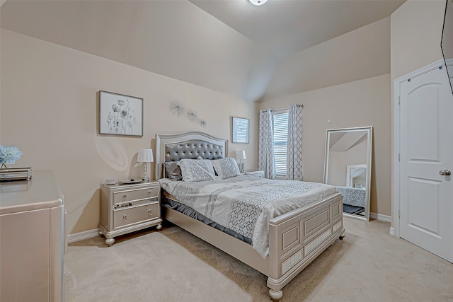 carpeted bedroom featuring vaulted ceiling