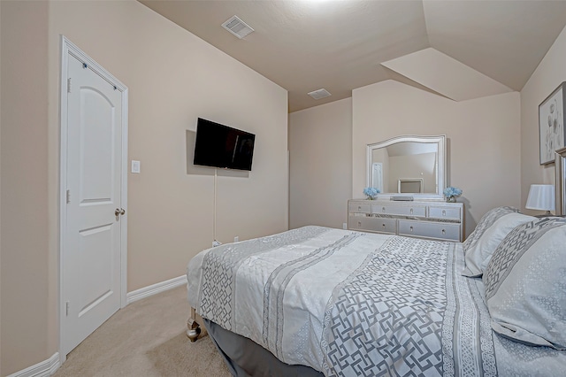 bedroom featuring light colored carpet and lofted ceiling