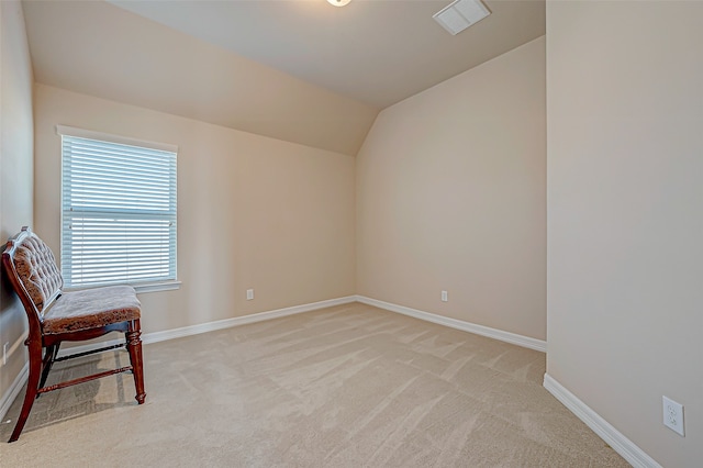 living area featuring light colored carpet and lofted ceiling