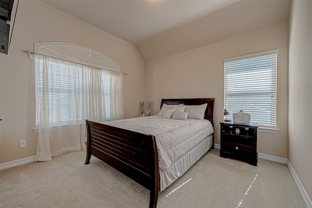 bedroom featuring multiple windows, light carpet, and vaulted ceiling