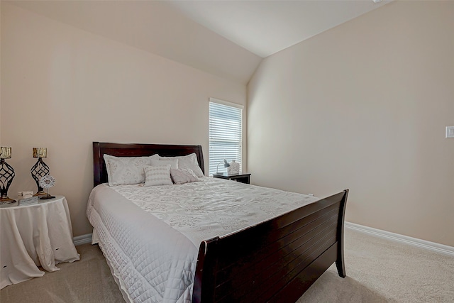 carpeted bedroom featuring lofted ceiling