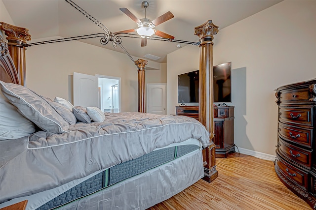 bedroom featuring ensuite bath, ceiling fan, vaulted ceiling, and light wood-type flooring