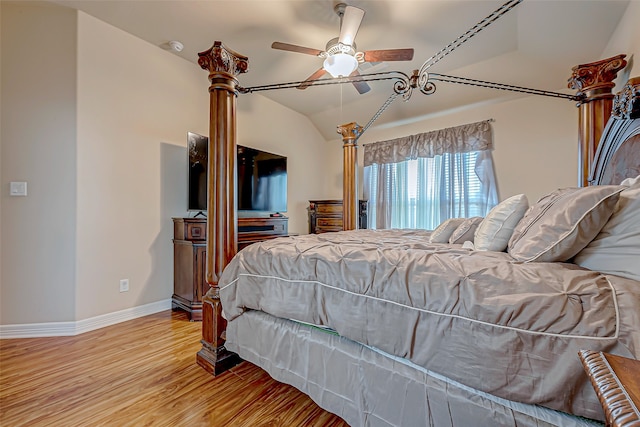 bedroom featuring ceiling fan, wood-type flooring, and lofted ceiling