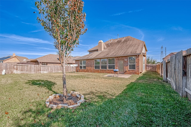 back of property featuring a yard and a patio