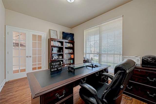 office space featuring light hardwood / wood-style floors and french doors