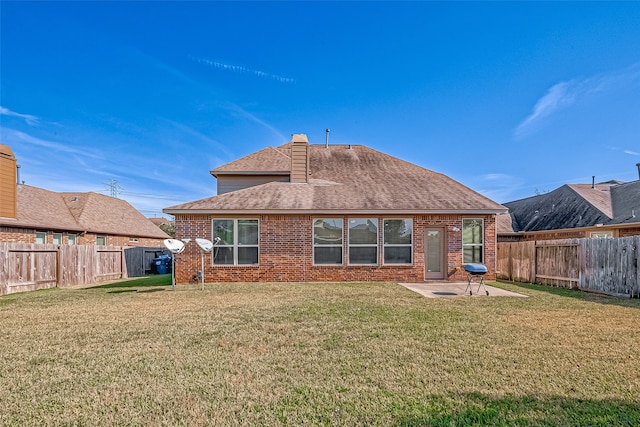 rear view of property featuring a lawn and a patio