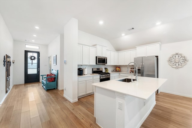 kitchen featuring white cabinets, sink, stainless steel appliances, and light hardwood / wood-style flooring