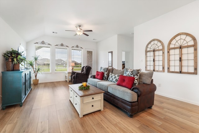 living room with ceiling fan, light hardwood / wood-style flooring, and lofted ceiling