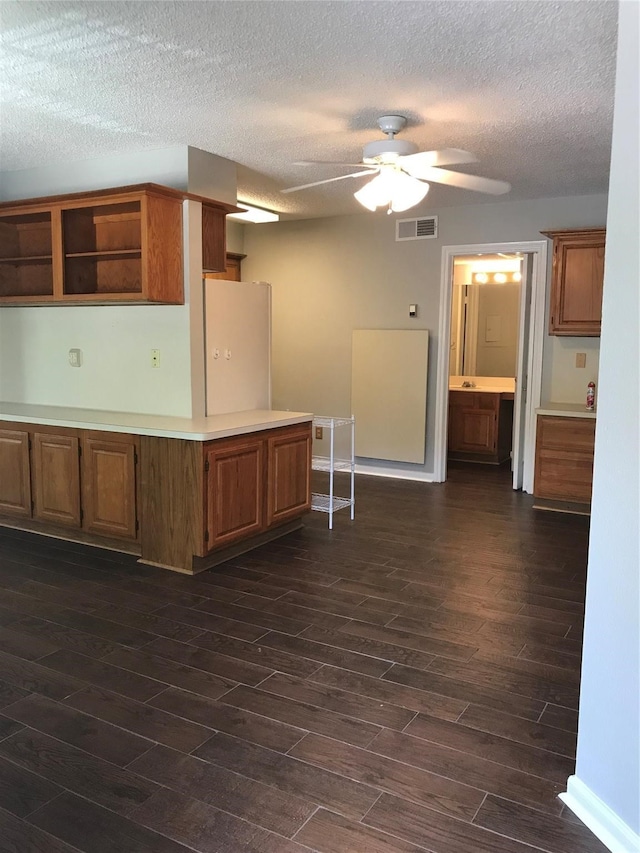 kitchen with ceiling fan, dark hardwood / wood-style flooring, a textured ceiling, and white refrigerator