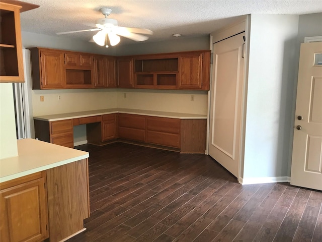 kitchen featuring a textured ceiling, dark hardwood / wood-style floors, ceiling fan, and built in desk