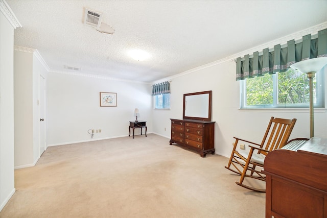 sitting room with a textured ceiling, light colored carpet, a wealth of natural light, and crown molding