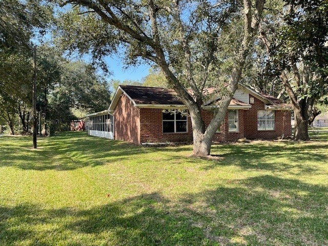 exterior space with a sunroom and a front lawn