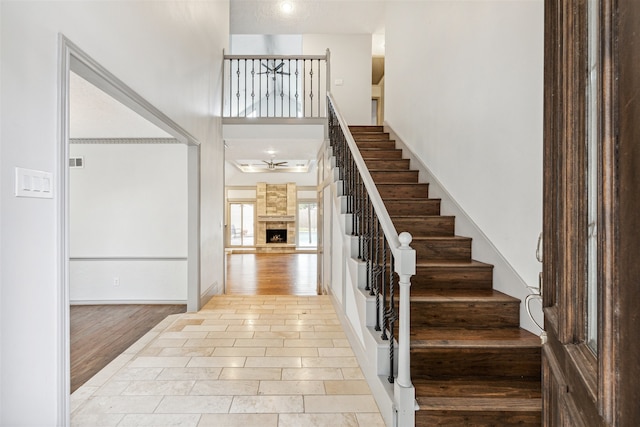 entryway with a stone fireplace and light wood-type flooring