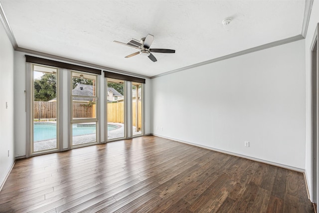 empty room featuring hardwood / wood-style flooring, ceiling fan, and ornamental molding