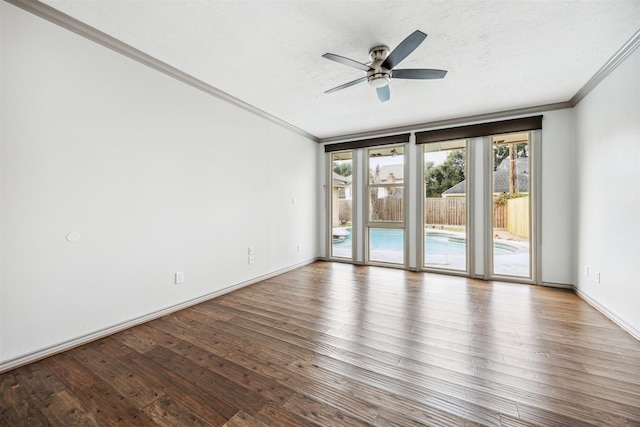 spare room with ceiling fan, wood-type flooring, a textured ceiling, and ornamental molding