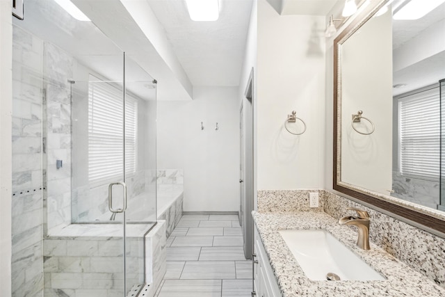 bathroom featuring plus walk in shower and vanity