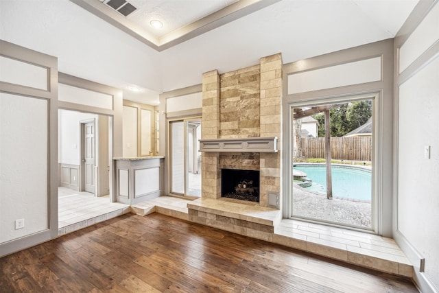 unfurnished living room featuring a fireplace and wood-type flooring